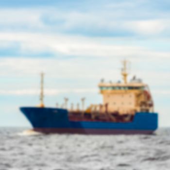 Blue cargo ship - soft lens bokeh image. Defocused background