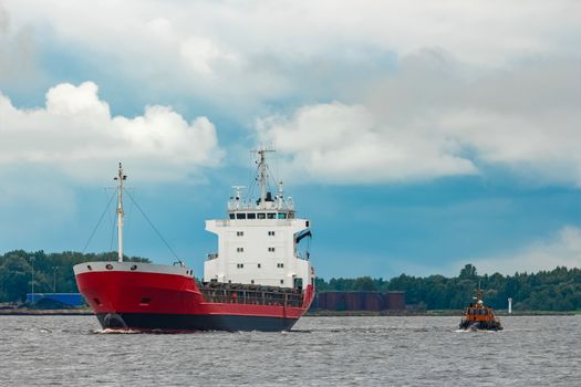 Red new cargo ship moving abroad. Product export in Europe