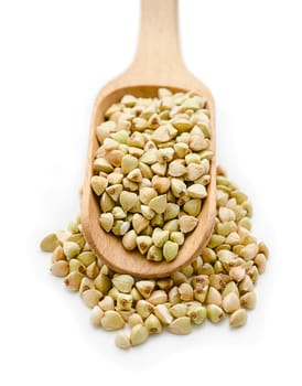 Buckwheat grain in wooden scoop isolated on white background.