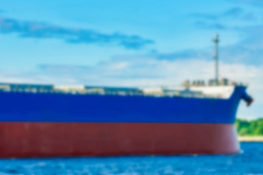 Blue cargo ship - soft lens bokeh image. Defocused background