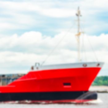 Red cargo ship - soft lens bokeh image. Defocused background