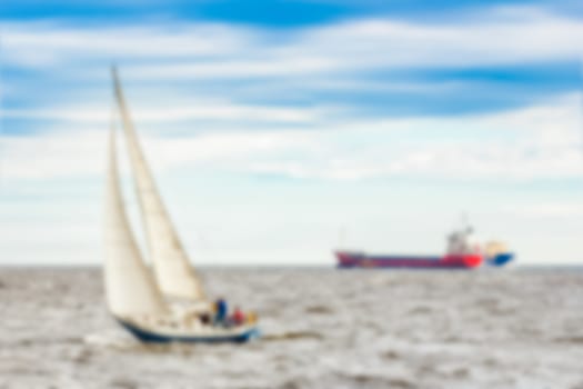 Blue sailboat - soft lens bokeh image. Defocused background