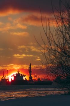 Colorful winter sunrise against the cargo port