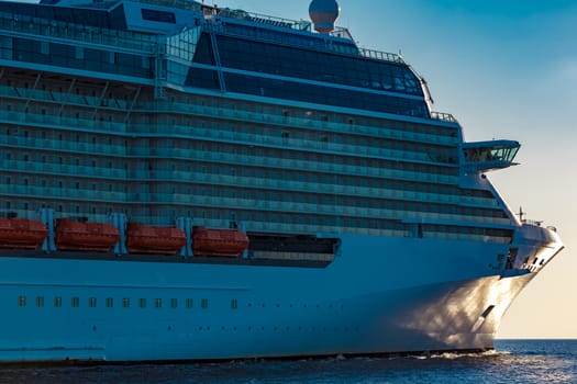 White giant brand new passenger ship moving in clear summer day