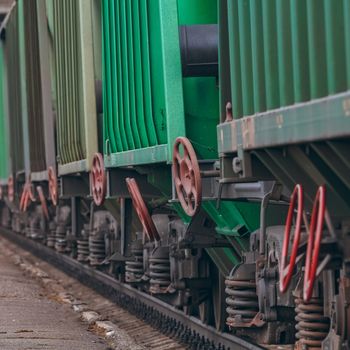 Green cargo wagons. Freight train in action