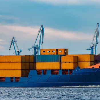 Blue container ship. Global logistics and merchandise transfer