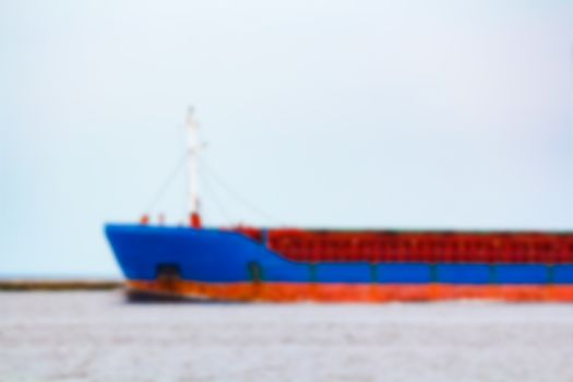 Blue cargo ship - soft lens bokeh image. Defocused background