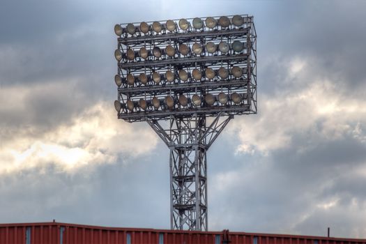 Photo of the stadium's lighting tower with a lot of spotlights.