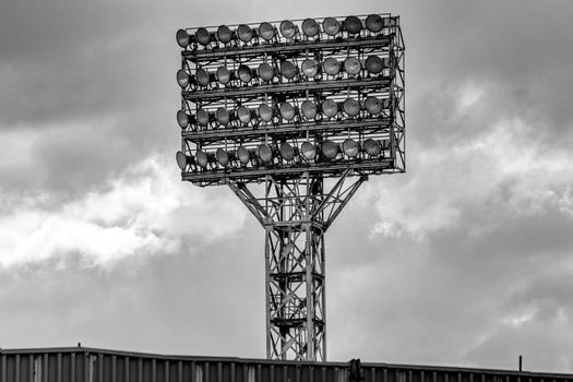 Photo of the stadium's lighting tower with a lot of spotlights.