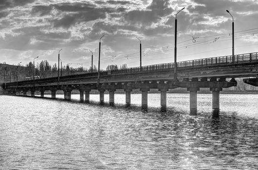 Photo of an industrial bridge through an artificial reservoir in the city.