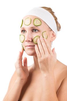 A young girl makes a face mask.