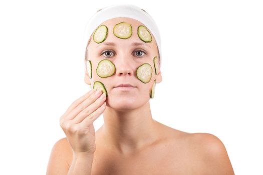 A young girl makes a face mask.