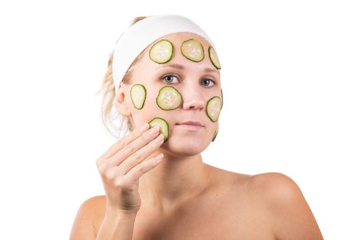 A young girl makes a face mask.