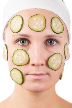 A young girl makes a face mask.