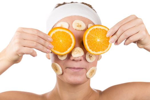 A young girl makes a face mask.