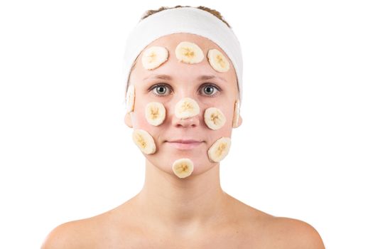 A young girl makes a face mask.