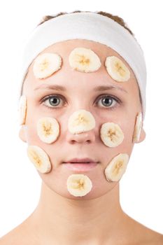 A young girl makes a face mask.