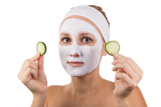 A young girl makes a face mask.