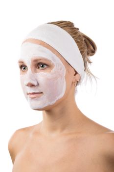 A young girl makes a face mask.