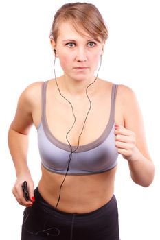Woman runs on a white background, in her ears headphones.