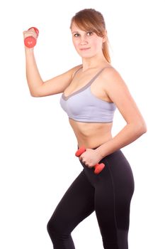 The girl goes in for sports with dumbbells on a white background.