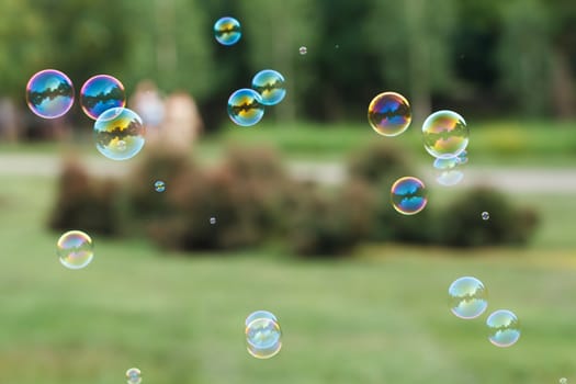 Soap ball in daylight against a background of greenery.