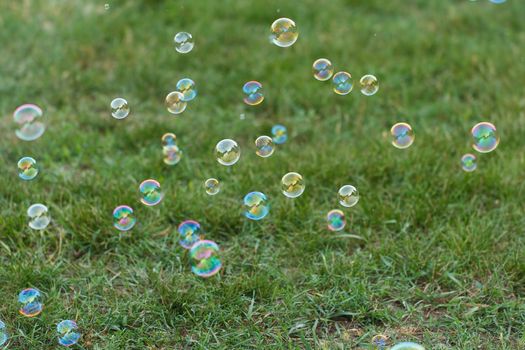 Soap ball in daylight against a background of greenery.