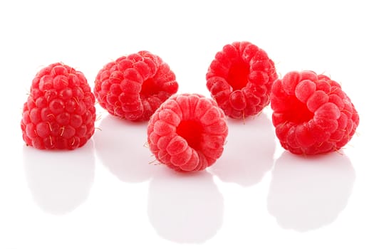 A bunch of ripe raspberries on white background.