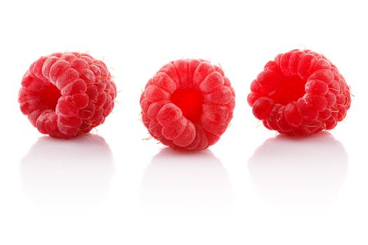 A bunch of ripe raspberries on white background.