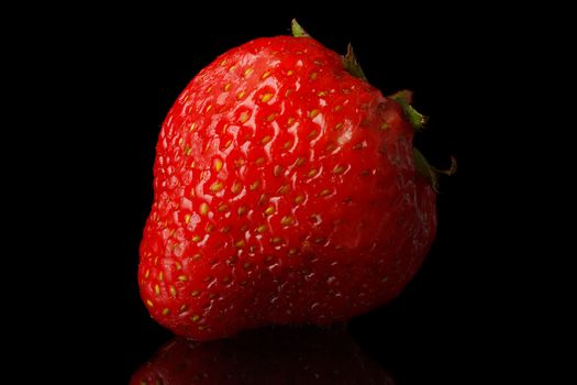 Natural fresh strawberries on a black background.
