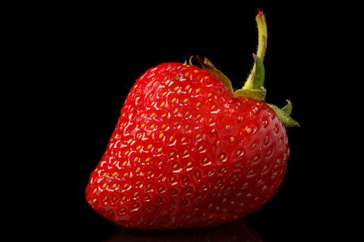 Natural fresh strawberries on a black background.
