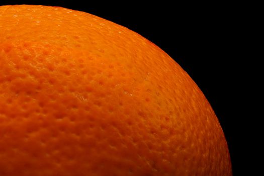 Photo of a ripe orange on a black background