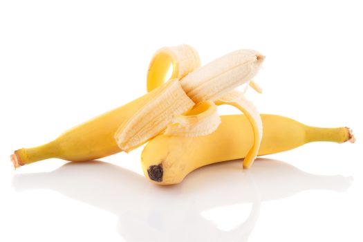 Half peeled ripe banana and another not peeled on a white background.
