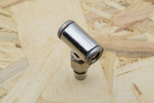 Air coupling connector, Pneumatic fitting on wood background.