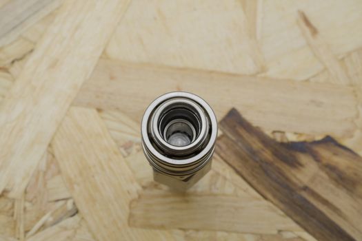 Air coupling connector, Pneumatic fitting on wood background.