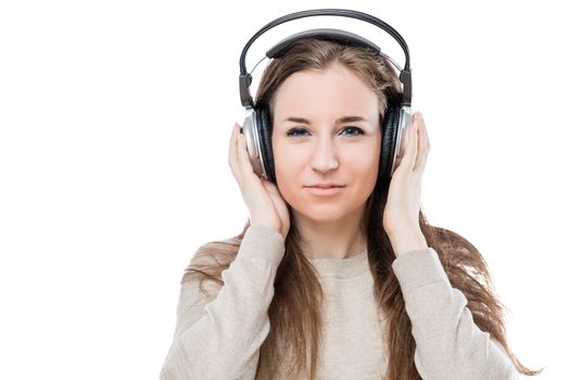 portrait of a girl with headphones listening to good music on a white background isolated