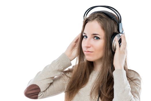 beautiful young girl with headphones posing on white background in studio, portrait isolated