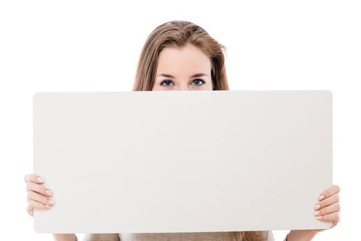 face of a beautiful girl half-covered with a poster for advertising on a white background