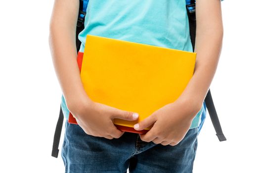 closeup of a schoolboy holding books, shooting on a white background in the studio