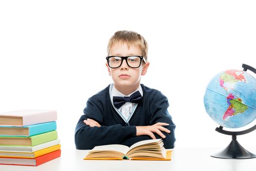 schoolboy with glasses at the table while studying