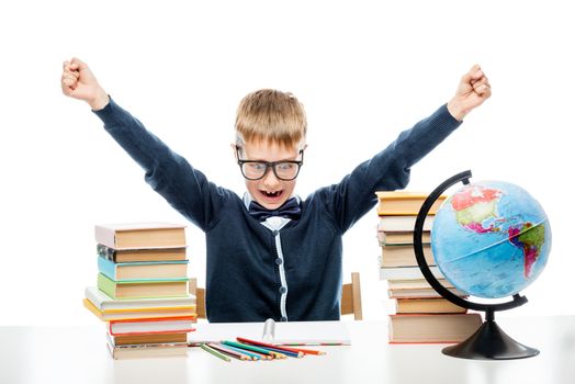 angry boy at table with books and globe against white background