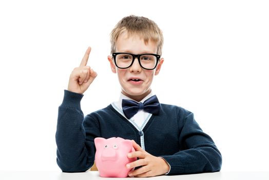 smart boy with a piggy bank came up with an idea, a portrait is isolated