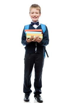 smiling schoolboy posing against white background, portrait is isolated in full length