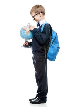 portrait of a schoolboy with magnifier and globe on a white background