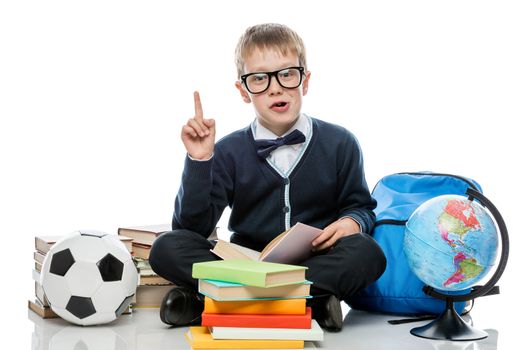 very smart boy with books, globe and soccer ball on white background