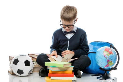 intelligent elementary school student with books on a white background