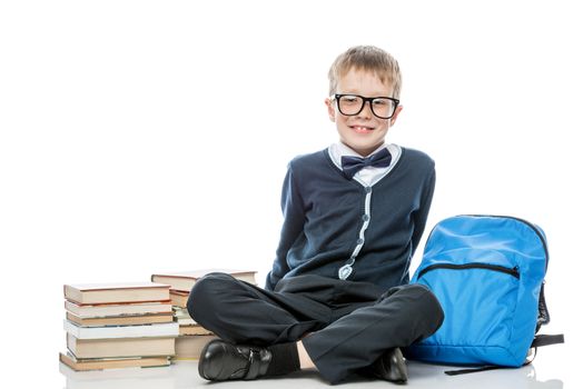 portrait of a happy schoolboy wearing glasses with a nigga and a backpack on a white background