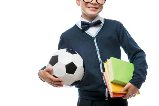 close-up of schoolboy's hand with ball and textbooks, schoolboy isolated