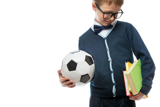 close-up of schoolboy with ball and textbooks, schoolboy isolated
