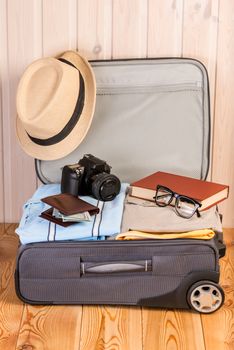 open suitcase with a broadcaster ready for a big trip